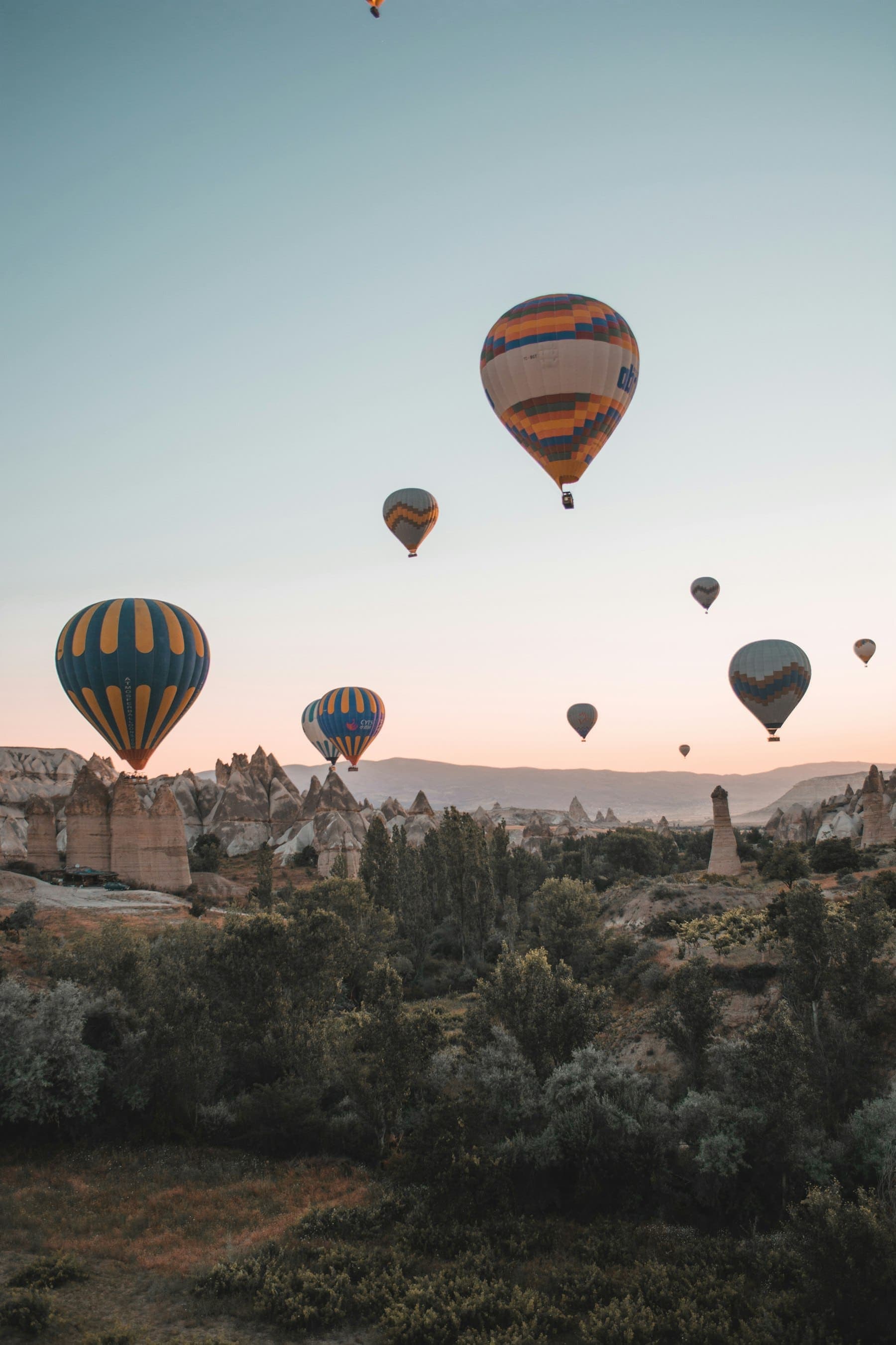 Hot-air balloons drifting over the rock valleys of Göreme, Cappadocia, at sunrise