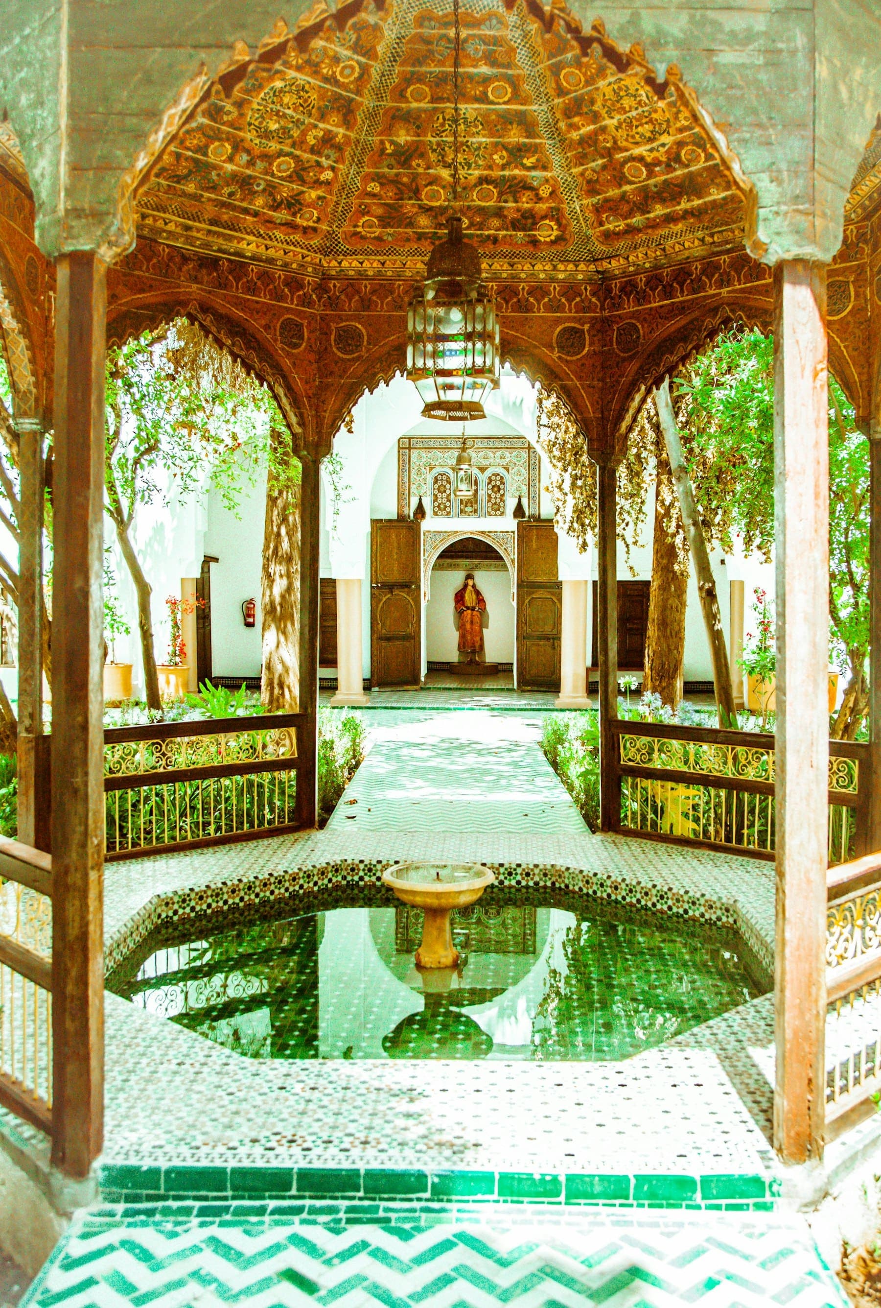 Carved cedar pavilion and tiled fountain in the courtyard of Dar Si Said, Marrakech